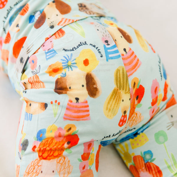 Close-up of The Second-Skin 2-Piece Short Sleeve Pajama fabric with Mindful Doggos hand-drawn dog prints.