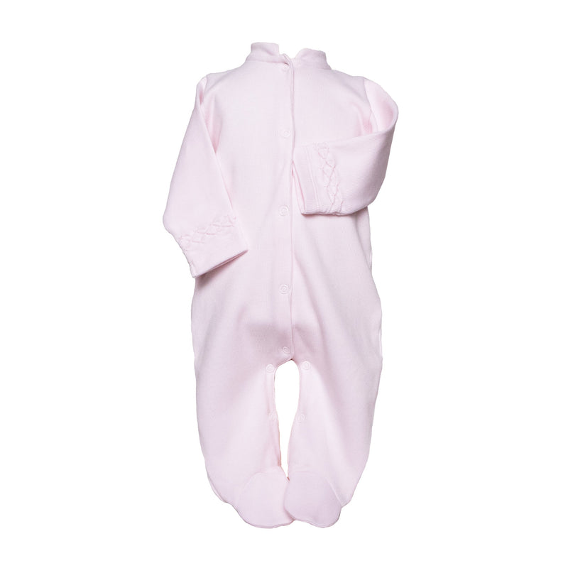 Pink baby footie with hand-smocked sleeve details, featuring long legs, enclosed feet, and front buttons for soft, elegant comfort.