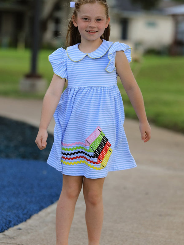 Girl in blue striped dress with a petal collar, ruffle sleeves, and crayon applique.