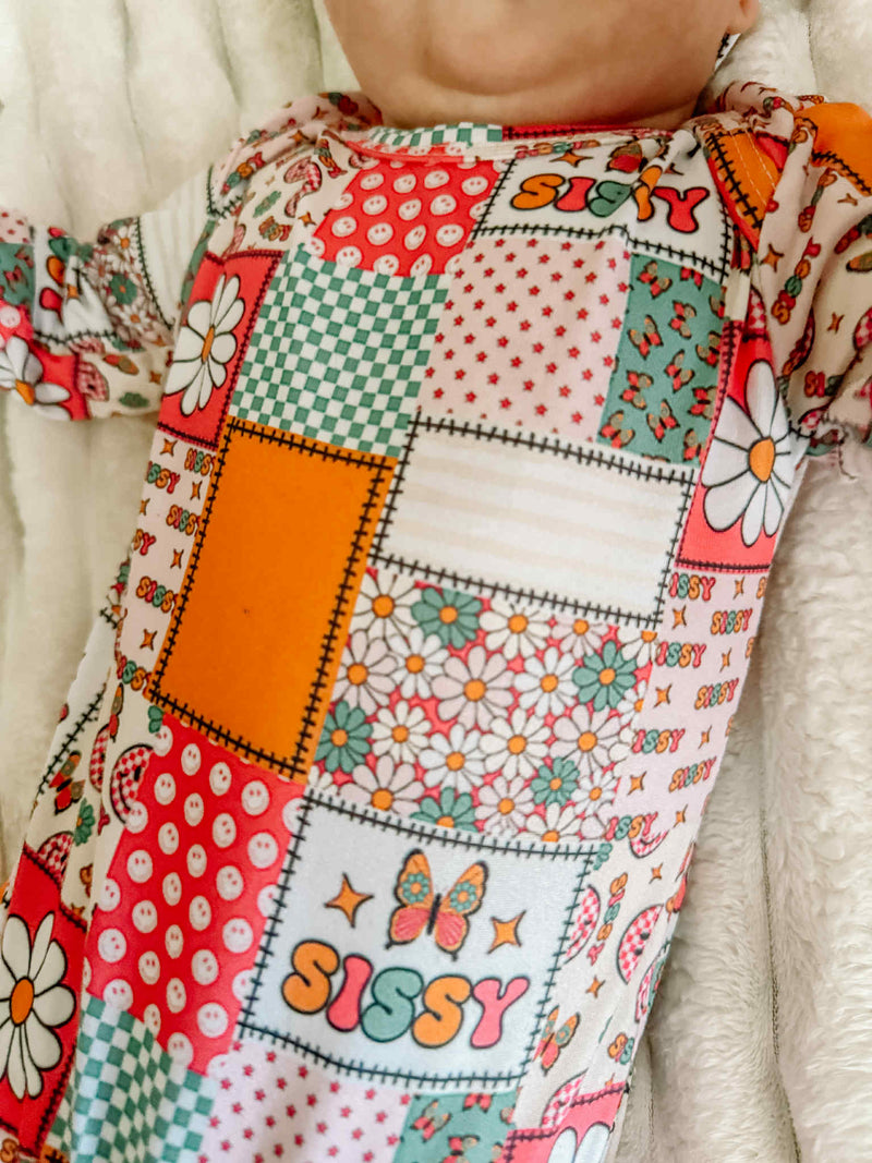 Detail of the Anti-Kick 'Sissy' Swaddle Gown, highlighting the playful retro patchwork design, perfect as a cozy baby swaddle gown for newborns.