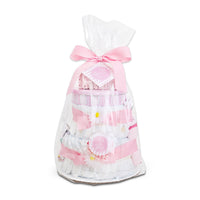 Gift bag with pink ribbons and baby-themed items on a white background