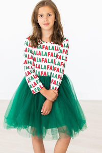 Girl wearing "Fa La La" long sleeve dress with festive red and green lettering and emerald green tulle skirt. Perfect holiday ballerina dress.