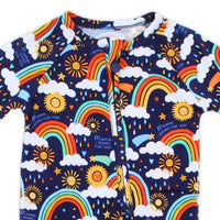 The Second-Skin Convertible Romper in Here Comes Sunshine Blue with rainbow sun clouds print, zippered, two-way.