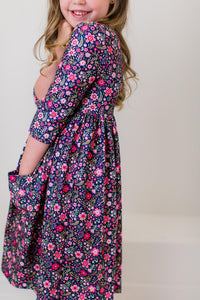 Girl in Flower Farm 3/4 Sleeve Pocket Twirl Dress with navy floral print and a full twirl-ready skirt.