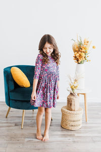 Girl in Flower Farm 3/4 Sleeve Pocket Twirl Dress with floral print and full twirl skirt.