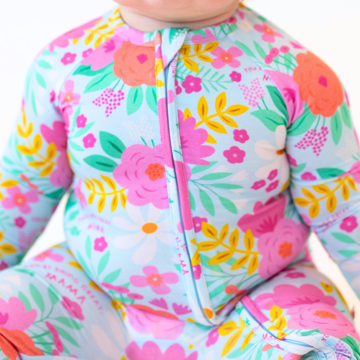 The Second-Skin Convertible Romper, Flower Power: vibrant floral print with pink front zipper.