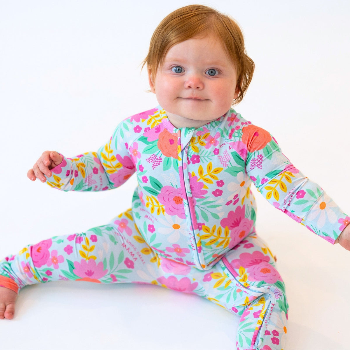 Baby wearing The Second-Skin Convertible Romper Flower Power floral print.