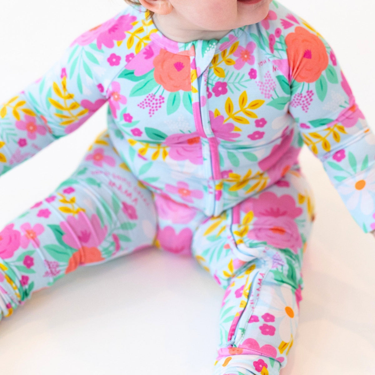 The Second-Skin Convertible Romper Flower Power in pastel floral print with zippered front.