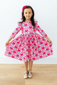 Toddler twirling in pink heart print 3/4 sleeve ruffle dress. Comfortable, easy-wash twirl gown designed for play and special occasions.