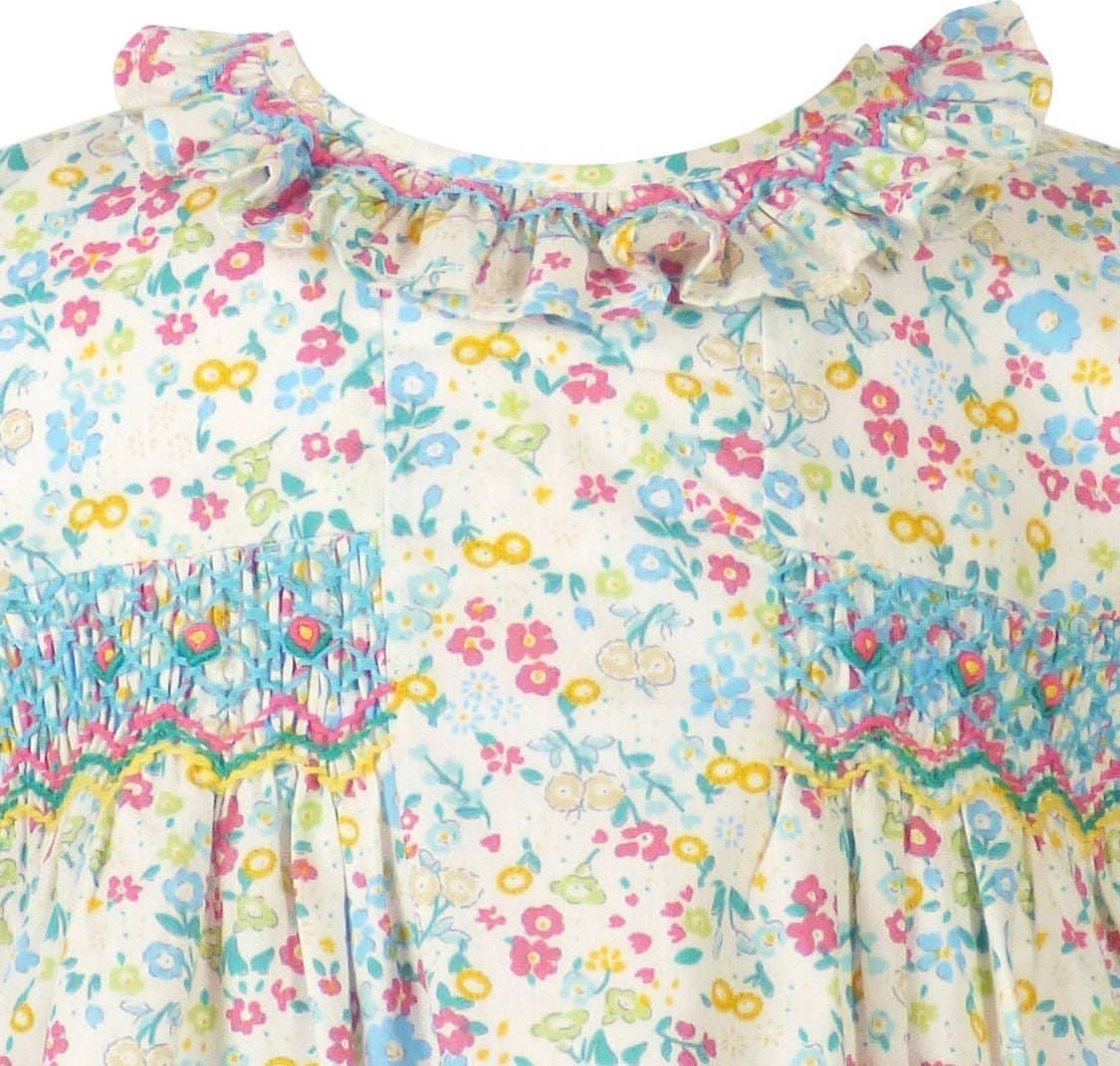 Close up of blue pink yellow diamond smocking on soft cotton fabric ruffled neckline