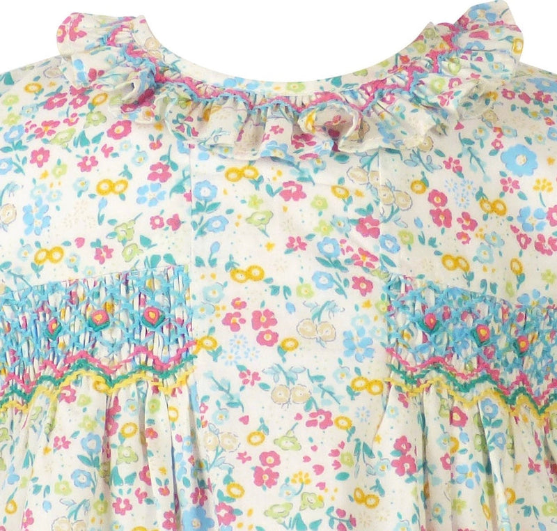 Close up of blue pink yellow diamond smocking on soft cotton fabric ruffled neckline
