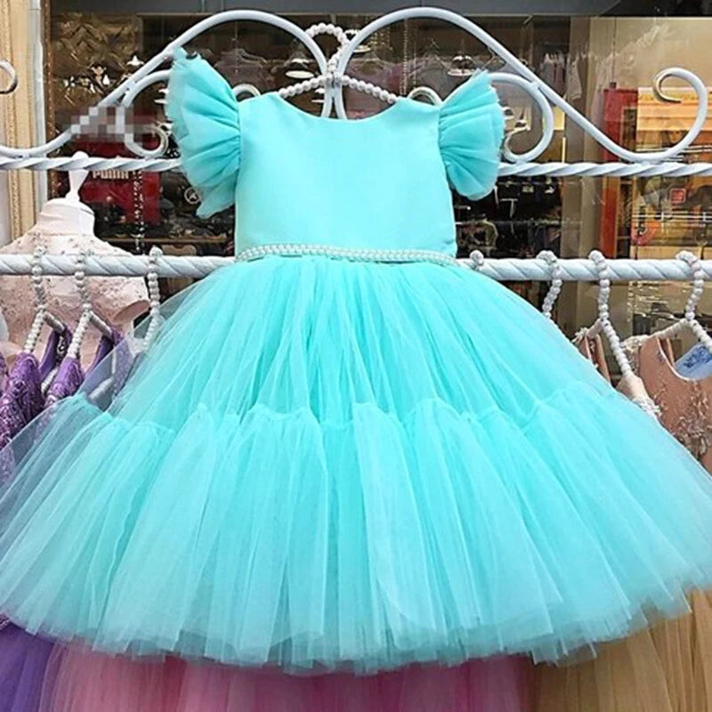 Pretty In Tulle Girls Tulle Party Dress in mint green displayed on a hanger, featuring stylish V-back and big bow, perfect for special occasions.