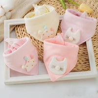 Soft pink and cream cotton triangle baby bibs featuring 3D cat and crown appliques to keep infants dry during feeding.