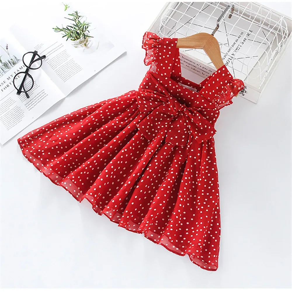 Red polka dot party dress for toddlers with ruffle sleeves and bow detail