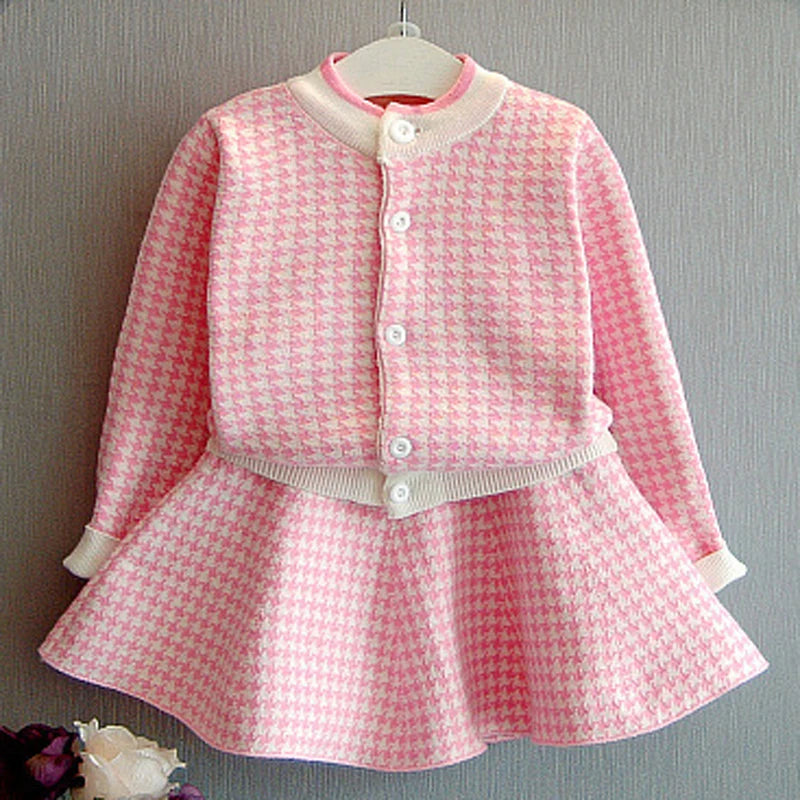 Sacha Marie Knitted Girls Houndstooth Skirt Set in princess pink, featuring a buttoned cardigan and twirl skirt design, perfect for little fashionistas.