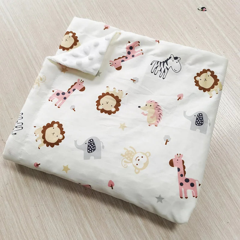 Two-sided children's Minky blanket with pastel animal prints (lion, elephant, zebra, giraffe) and raised dot texture.