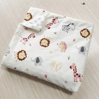 Two-sided children's Minky blanket with pastel animal prints (lion, elephant, zebra, giraffe) and raised dot texture.