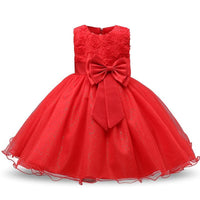 Red girls special occasion dress featuring floral lace bodice, large satin bow, and glittery tulle skirt.
