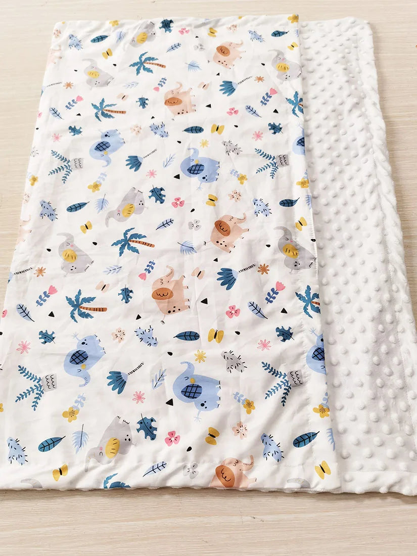 Two-sided children's minky blanket with colorful prints and raised-dot back, 100x75 cm.