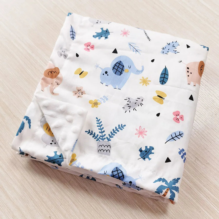 Two-sided Minky blanket with raised dots and cute prints, 100x75 cm, white with blue elephants and colorful motifs.
