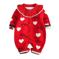 Red baby romper with white hearts and 'STU' text on a white background