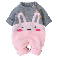 Baby outfit with pink bunny design and gray sweater on a white background