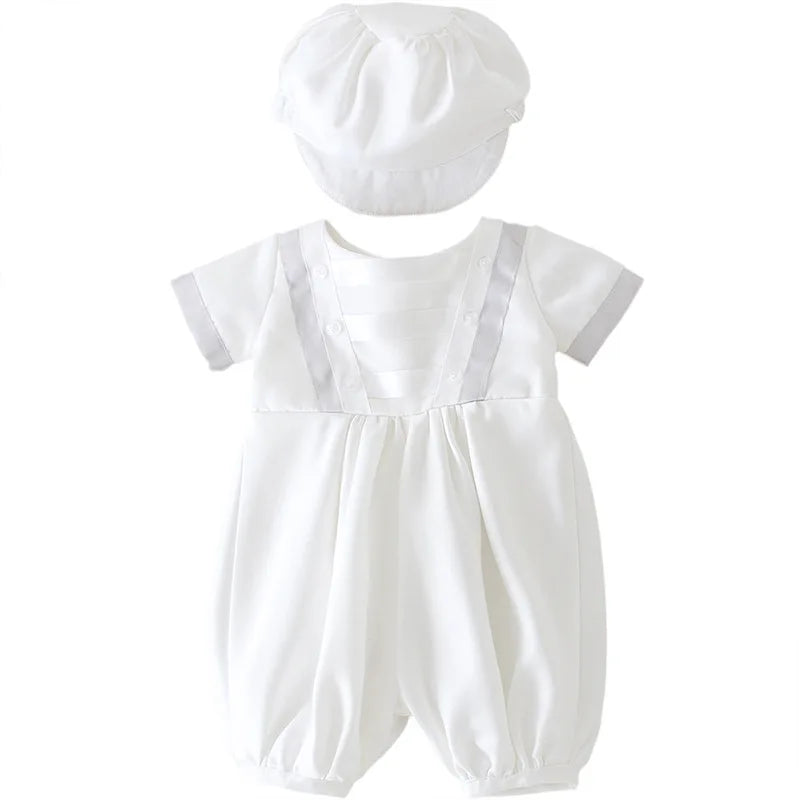 White baby romper set with matching cap. Formal special occasion bodysuit with pleated front, suspenders, and short sleeves for infants.