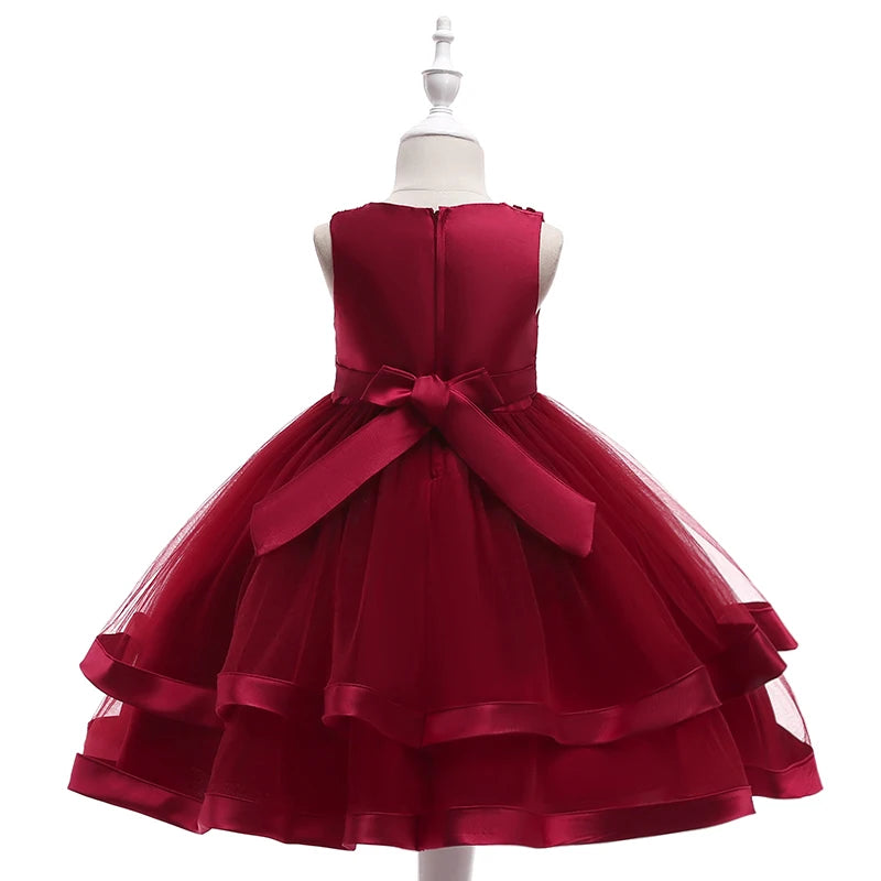 Back view of the Sacha Marie Elegant Tiered Special Occasion Dress in burgundy, highlighting the flowing tiered skirt and elegant bow detail.