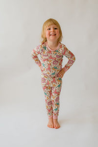 Toddler modeling bamboo pajama set with sea-themed pattern