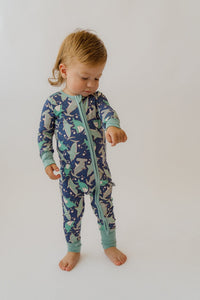 Toddler wearing soft, convertible shark print bamboo loveall onesie with front zipper for cozy sleep and play.