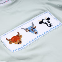 Embroidered patch with animal designs on a light green fabric background