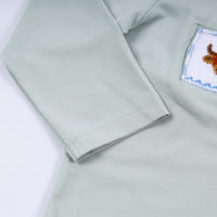 Light green shirt with a patch on the sleeve