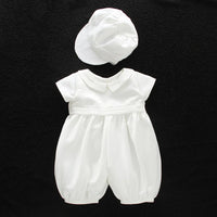 White baby romper with turn-down collar and lace detail paired with matching bonnet for special occasion formal wear.