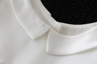 Close-up of a white turn-down collar on a mason dapper formal outfit for boys, featuring a smooth cotton polyester blend.