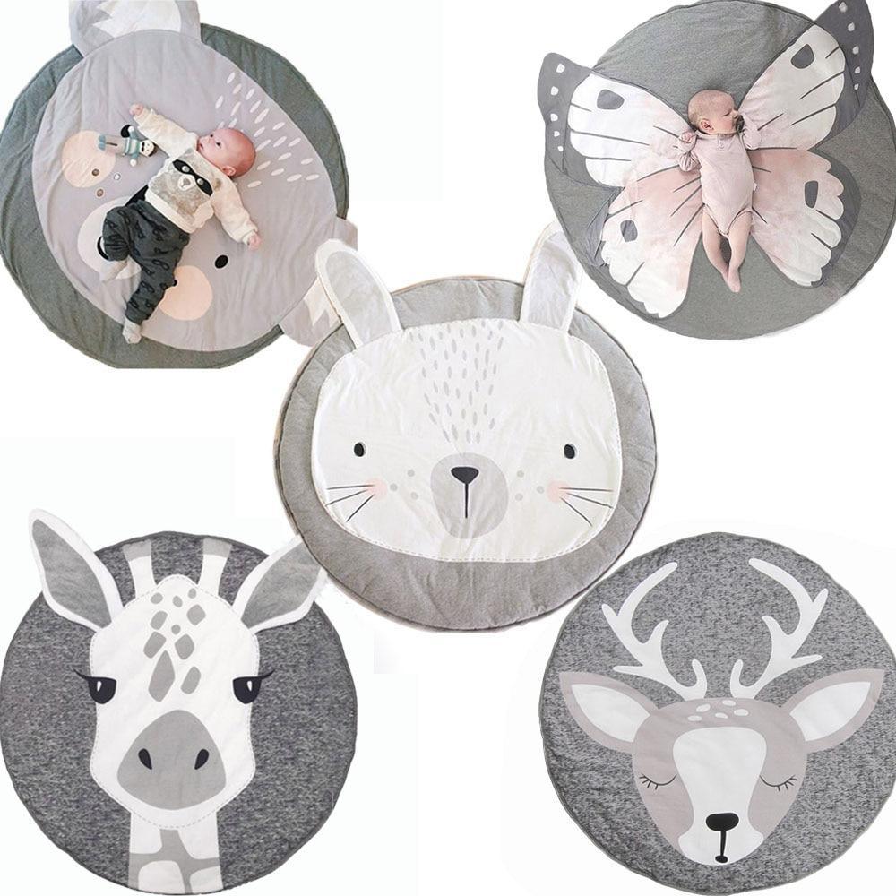 Set of round animal-themed mats with plush toys on a white background