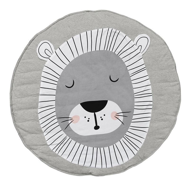 Round gray cushion with a lion face design on a white background