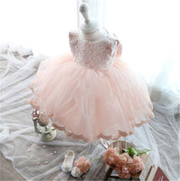 Pink girls' special occasion dress with lace bodice and tulle skirt, featuring cotton lace blend material and scalloped hem.
