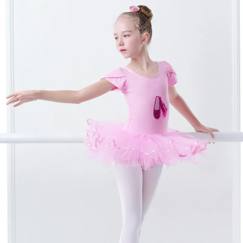 Side view of a little girl in the 'Poppy' Pink Sequined Slipper Chiffon Tutu Dress, highlighting the shimmering design and tutu skirt, perfect for dance.