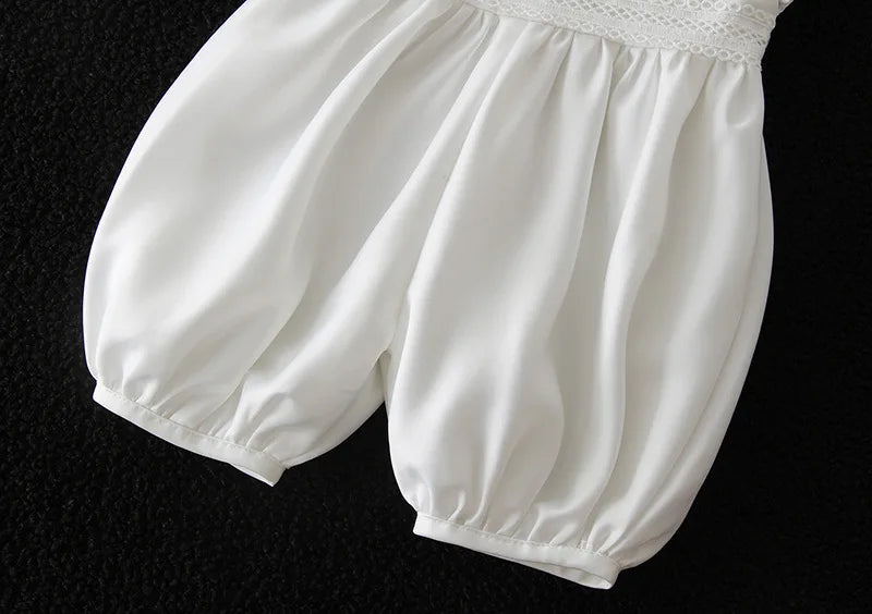White baby bloomers with elastic cuffs and lace waistband for formal special occasion outfits.