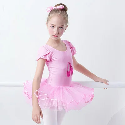 A young ballerina in the 'Poppy' Pink Sequined Slipper Chiffon Tutu Dress, showcasing the tutu’s vibrant pink layers and its suitability for dance activities.
