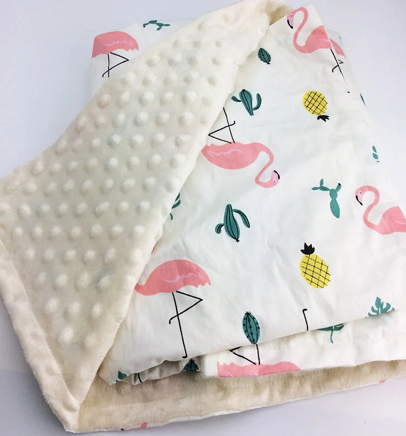 Dotted cream minky blanket with white fabric featuring pink flamingos, yellow pineapples, and green cacti.