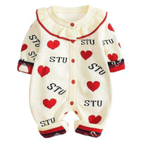 Baby romper with red hearts and 'STU' text on a white background