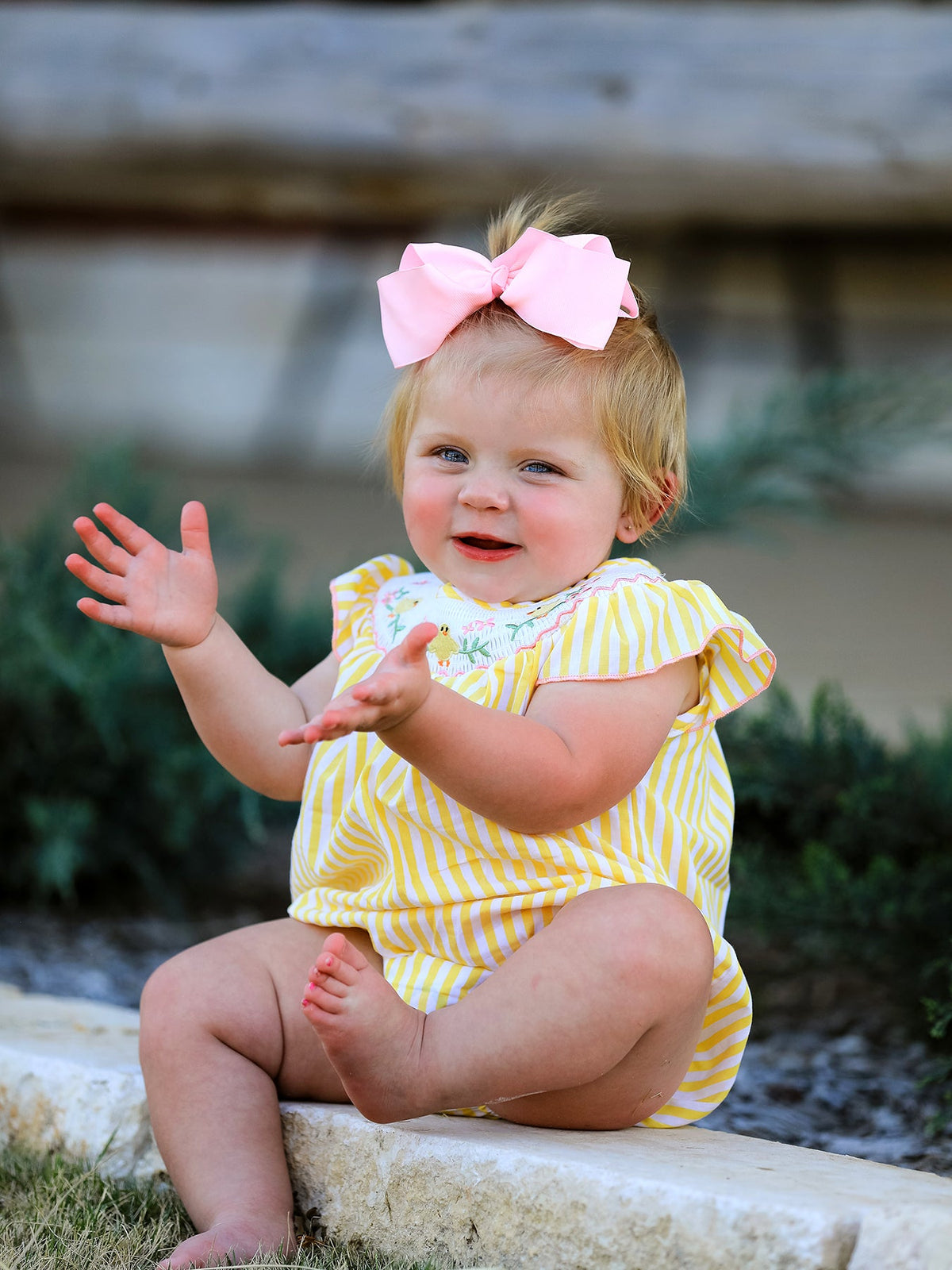 Side view of Spring/Summer Chick Floral Embroidery Smocking Girls Romper demonstrating its fitted smocking details and playful design.