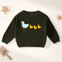Dark green crewneck sweater with duck embroidery and SWaddle AN tag inside collar with wooden toys