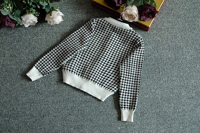 Back view of the Sacha Marie Knitted Girls Houndstooth skirt in black, showcasing the design of this fashionable skirt set for girls.