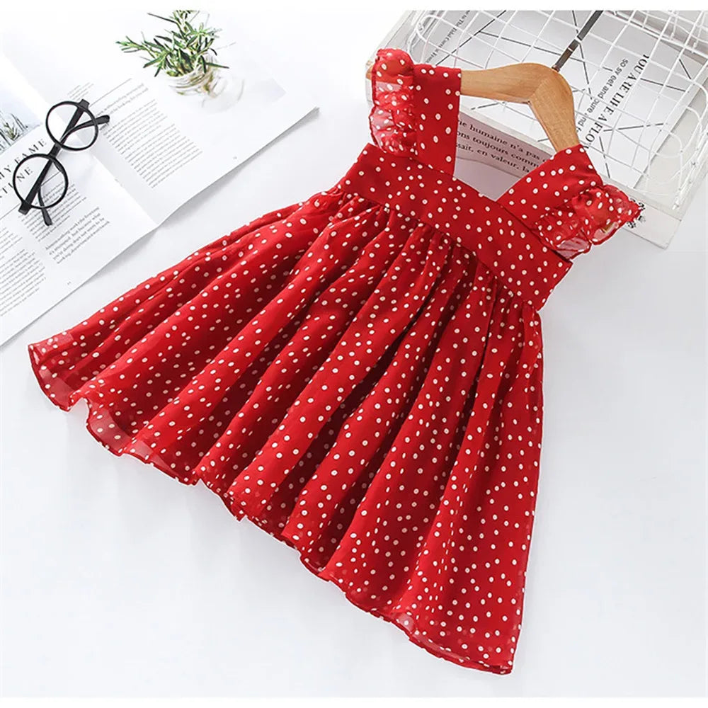 Red polka dot party dress for girls with ruffle straps and gathered skirt