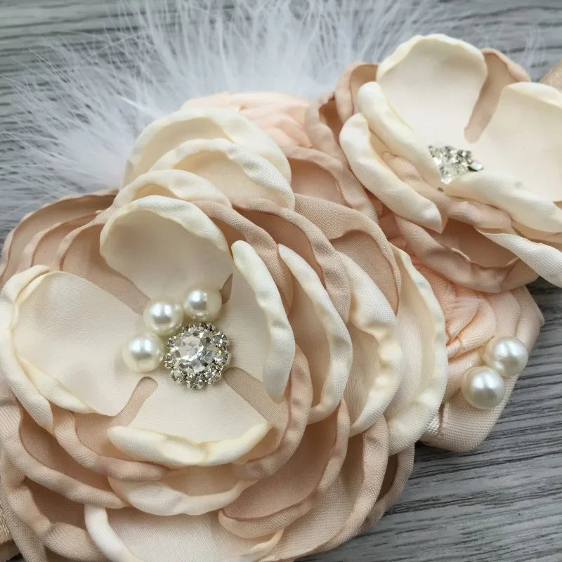Elegant Chiffon Beaded Baby Hair Accessories displaying an array of layered fabric flowers with embellishments, perfect for special events.