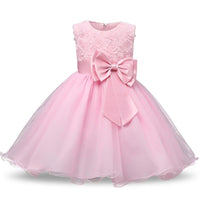 Pink girl special occasion dress with lace rose bodice, large satin bow waist, and glitter tulle skirt for weddings or parties.