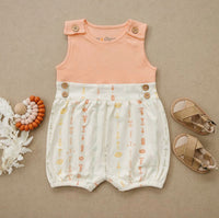 GOTS certified organic cotton baby romper with peach bodice and boho floral bubble bottom, featuring wooden buttons.