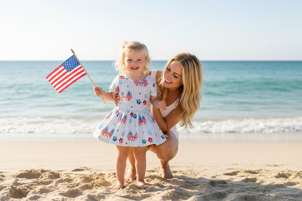 Children's dress with red, white, and blue floral pattern on a white background